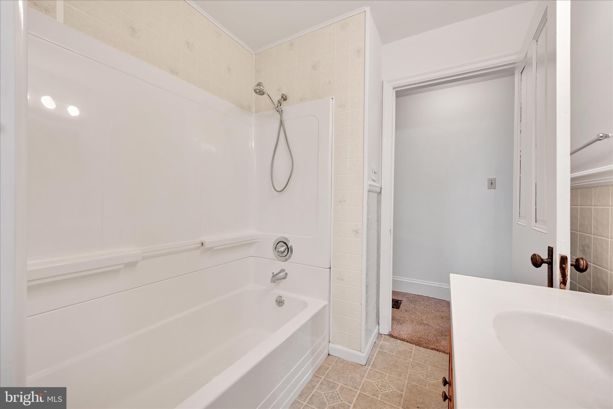 1211 River Road Quarryville, PA 17566 - Photo 18 of 33 a bathroom with a tub a sink and a shower