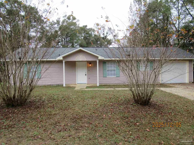 a large tree in the front of a house