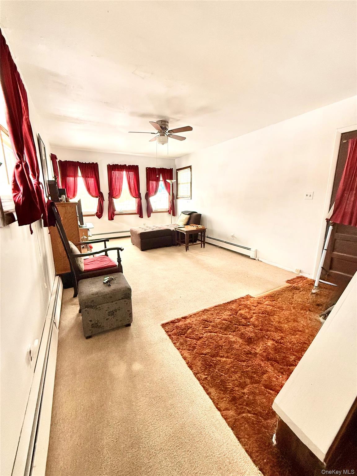 22 Blue Point Road Mastic Beach, NY 11951 - Photo 11 of 29 a living room with furniture and a flat screen tv