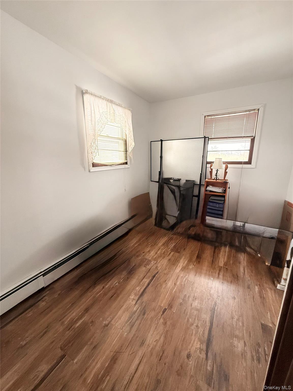 22 Blue Point Road Mastic Beach, NY 11951 - Photo 12 of 29 wooden floor in an empty room with a window