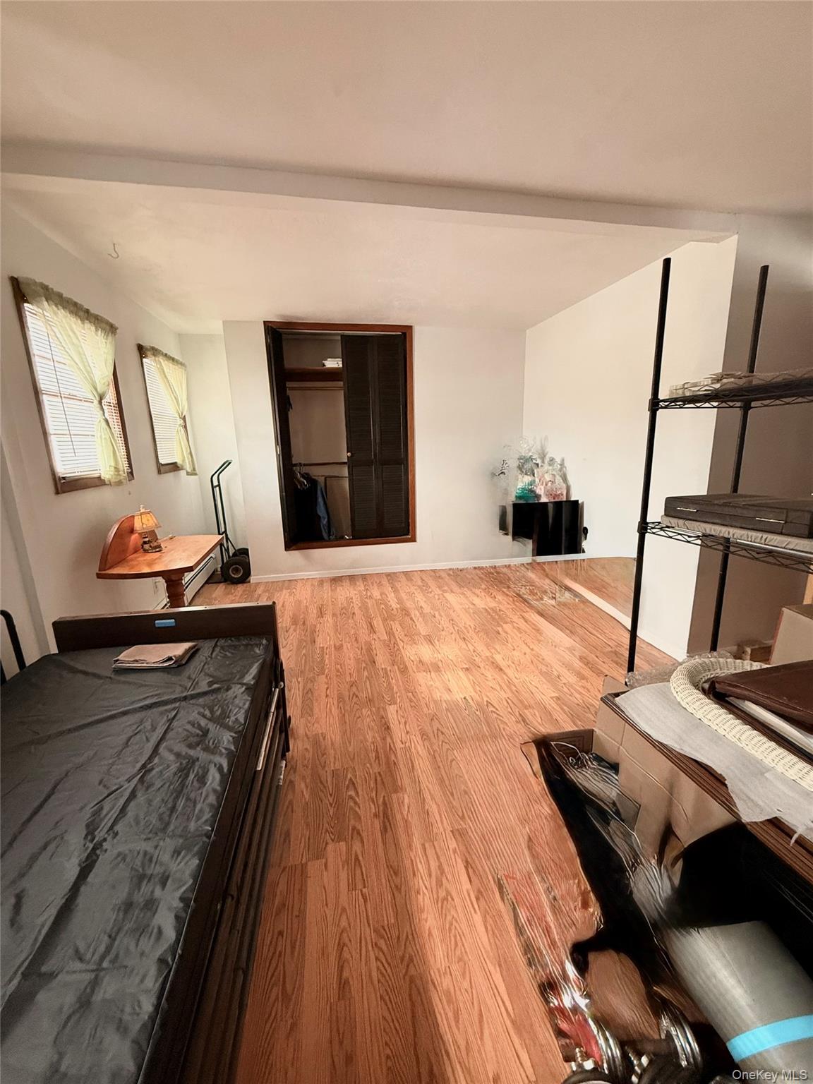 22 Blue Point Road Mastic Beach, NY 11951 - Photo 13 of 29 a bedroom with a bed and wooden floor