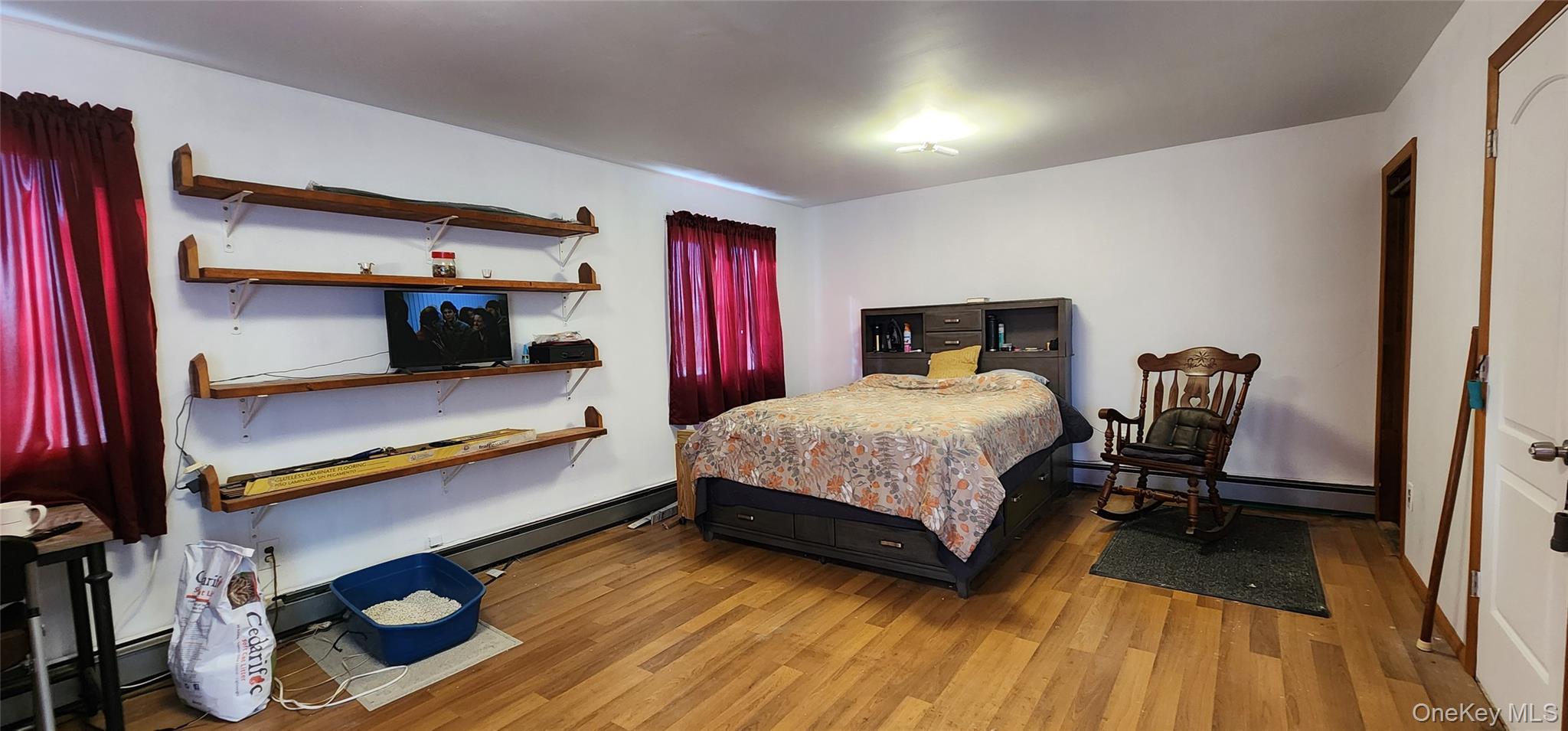 22 Blue Point Road Mastic Beach, NY 11951 - Photo 14 of 23 a bedroom with a bed and wooden floor