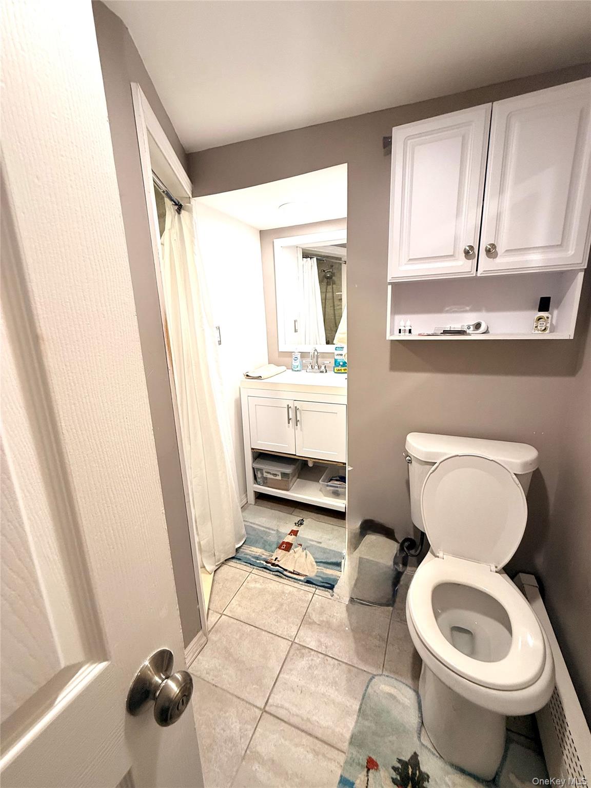 22 Blue Point Road Mastic Beach, NY 11951 - Photo 14 of 29 a bathroom with a toilet sink and mirror