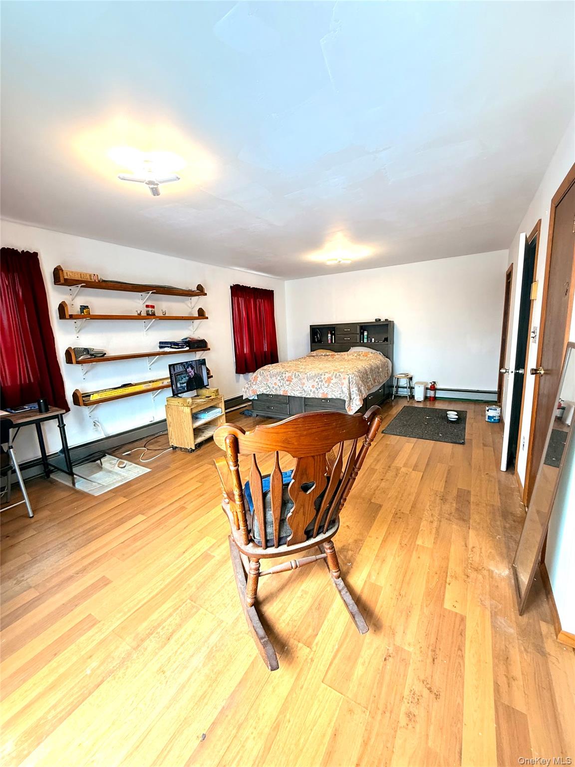 22 Blue Point Road Mastic Beach, NY 11951 - Photo 16 of 29 a room with gym equipment and wooden floor