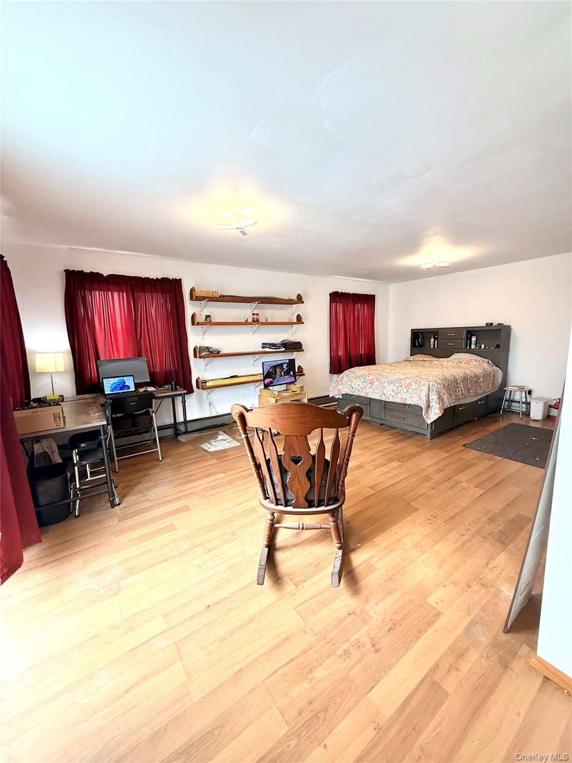 22 Blue Point Road Mastic Beach, NY 11951 - Photo 17 of 29 a living room with furniture and a flat screen tv with kitchen view