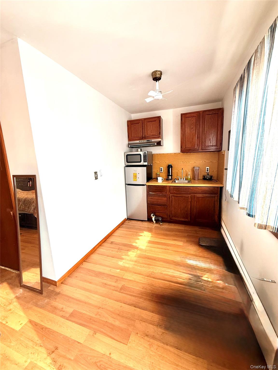 22 Blue Point Road Mastic Beach, NY 11951 - Photo 18 of 29 a kitchen with stainless steel appliances a refrigerator sink and microwave