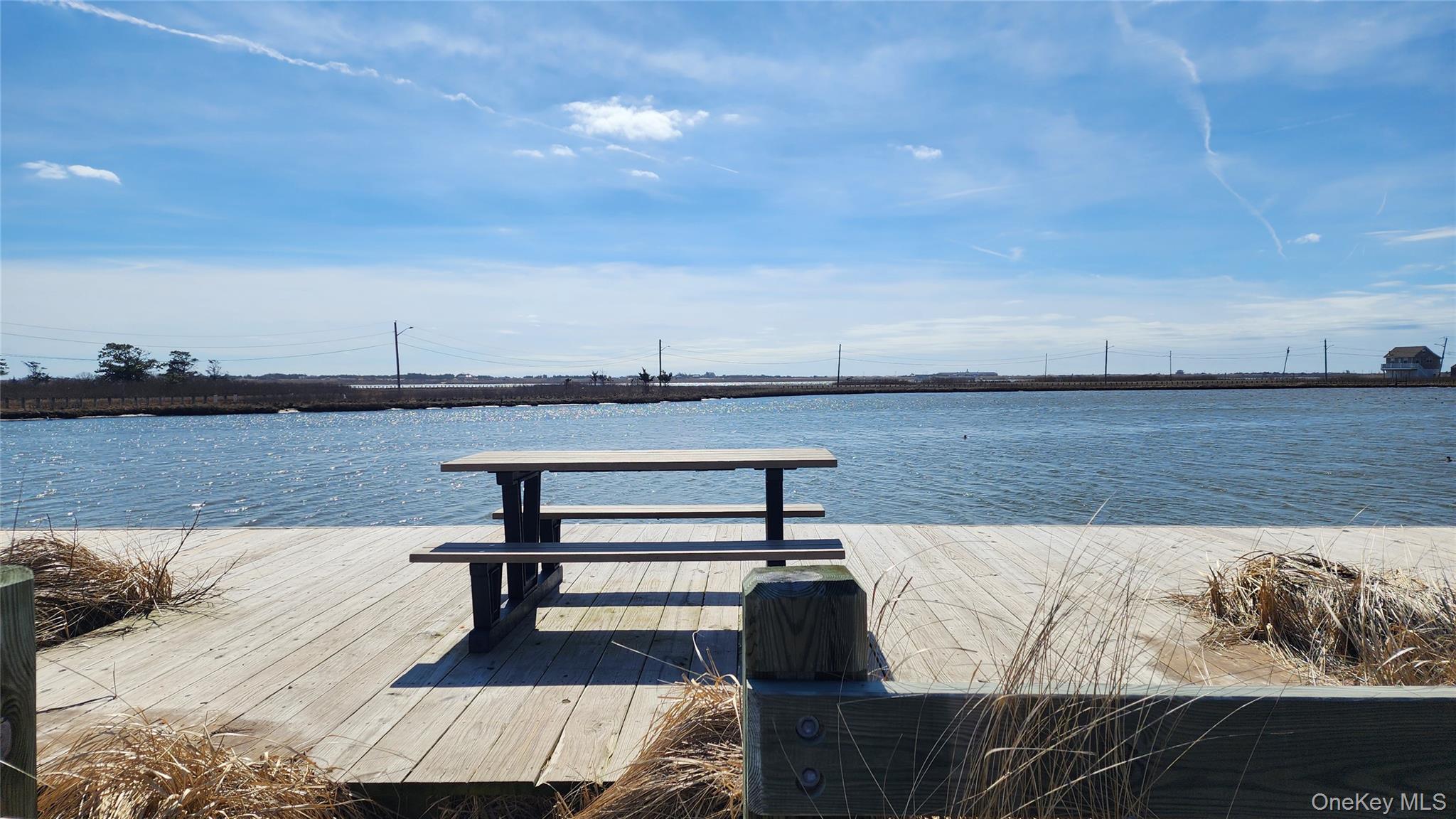 22 Blue Point Road Mastic Beach, NY 11951 - Photo 19 of 23 a view of a lake with outdoor seating