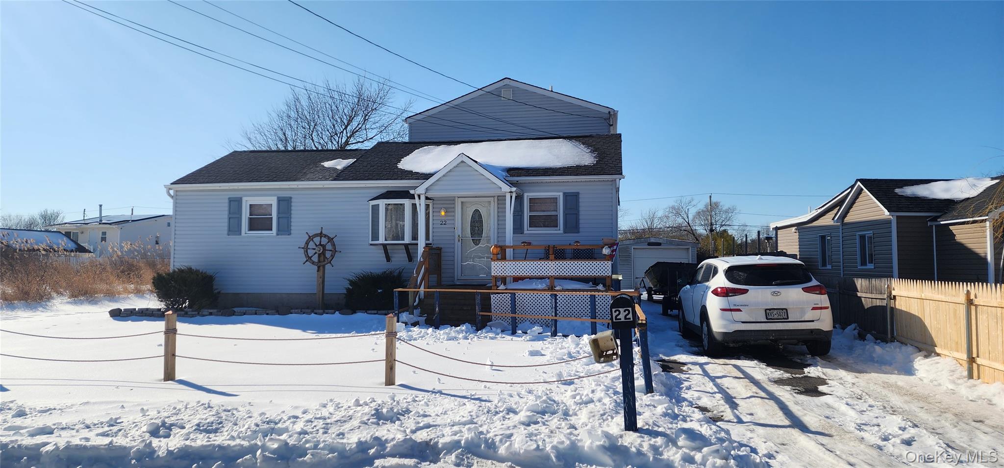 22 Blue Point Road Mastic Beach, NY 11951 - Photo 22 of 23 a front view of a house with a garden