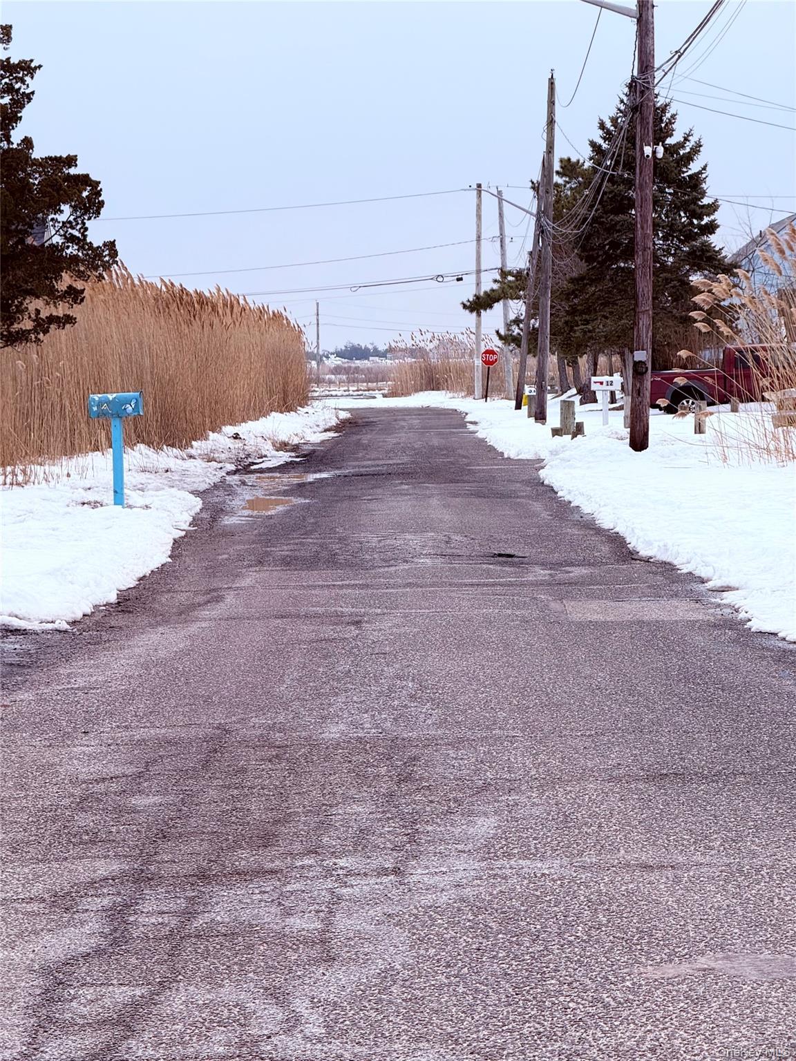 22 Blue Point Road Mastic Beach, NY 11951 - Photo 22 of 29 a view of road with snow on the side of road