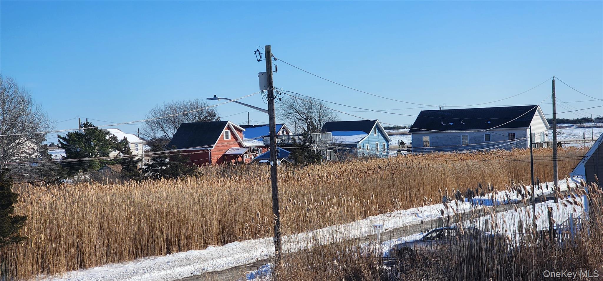 22 Blue Point Road Mastic Beach, NY 11951 - Photo 27 of 29 a view of a lake with boats and palm trees