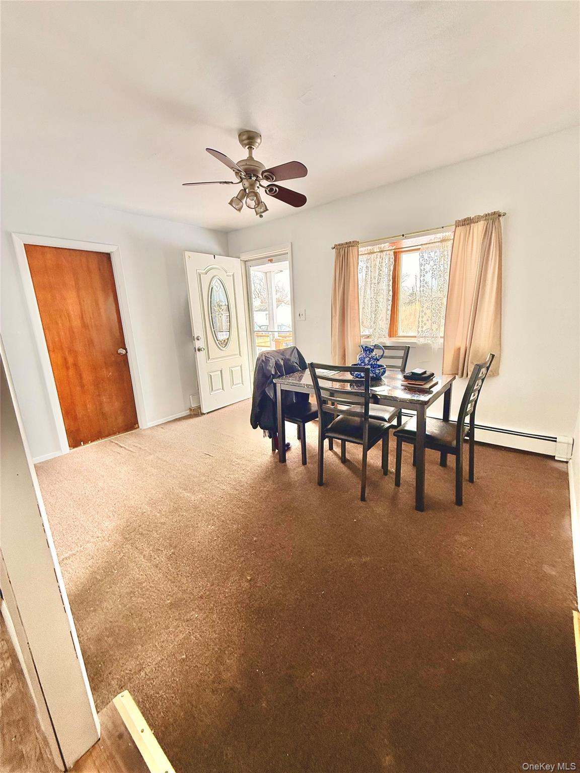 22 Blue Point Road Mastic Beach, NY 11951 - Photo 5 of 29 a dining room with furniture and chandelier