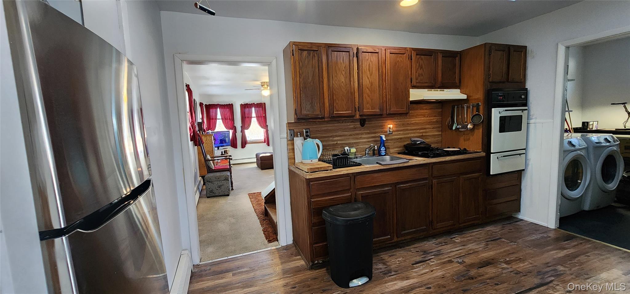 22 Blue Point Road Mastic Beach, NY 11951 - Photo 8 of 23 a kitchen with stainless steel appliances granite countertop a refrigerator a stove top oven a sink and dishwasher