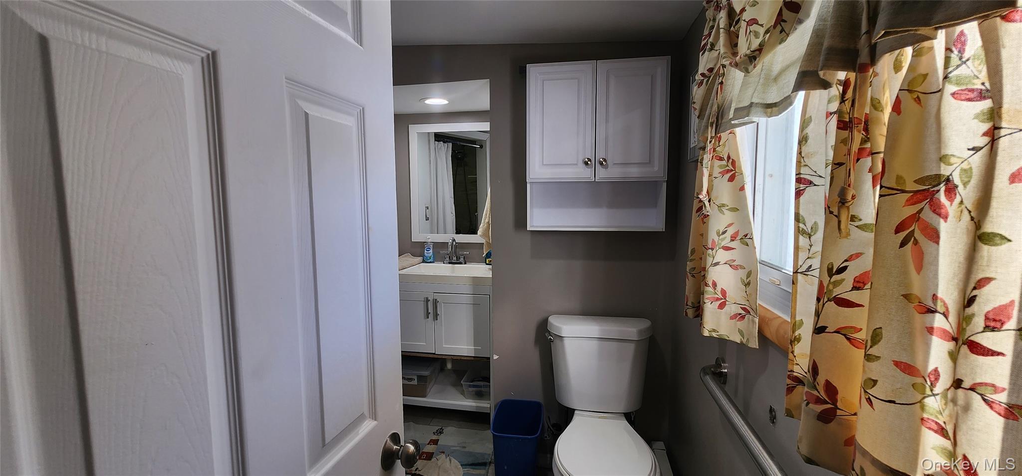 22 Blue Point Road Mastic Beach, NY 11951 - Photo 10 of 23 a white toilet sitting next to a bathroom sink