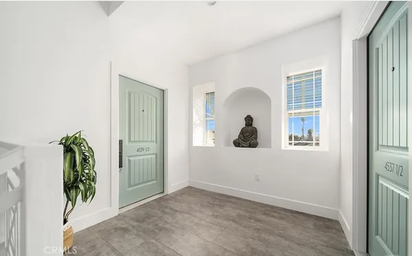a kitchen with granite countertop white cabinets and refrigerator