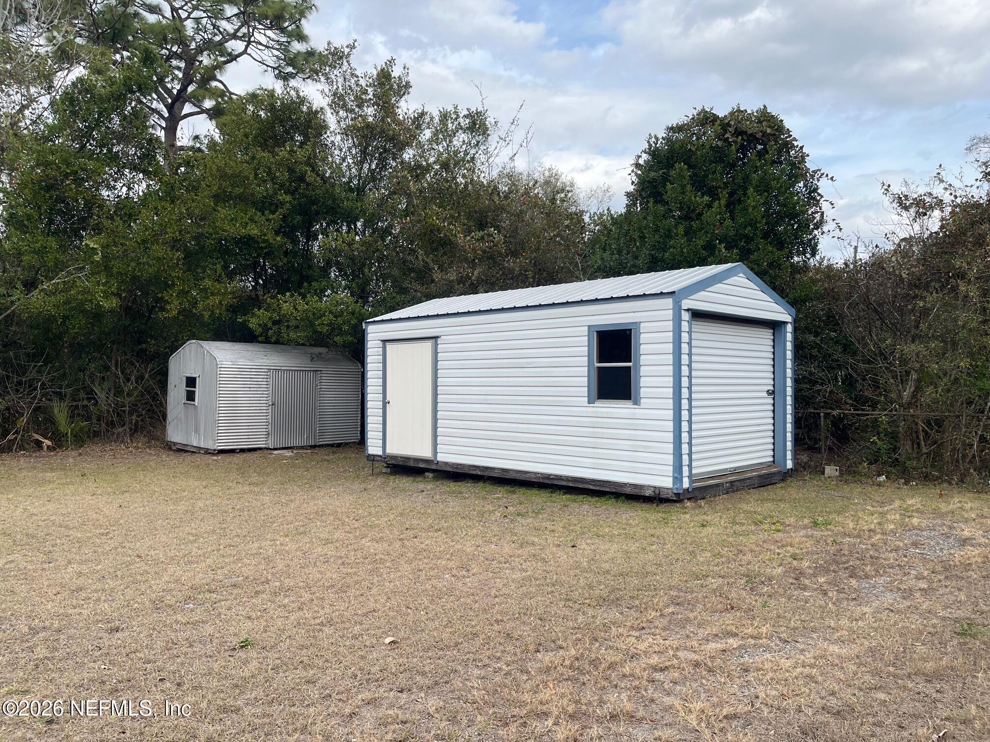 10547 Briarcliff Road East Jacksonville, FL 32218 - Photo 26 of 33 a view of a house with a yard and a large tree