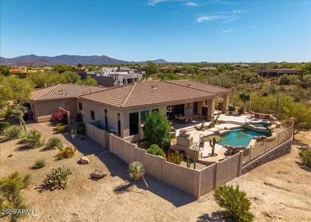 an aerial view of a house with a ocean view