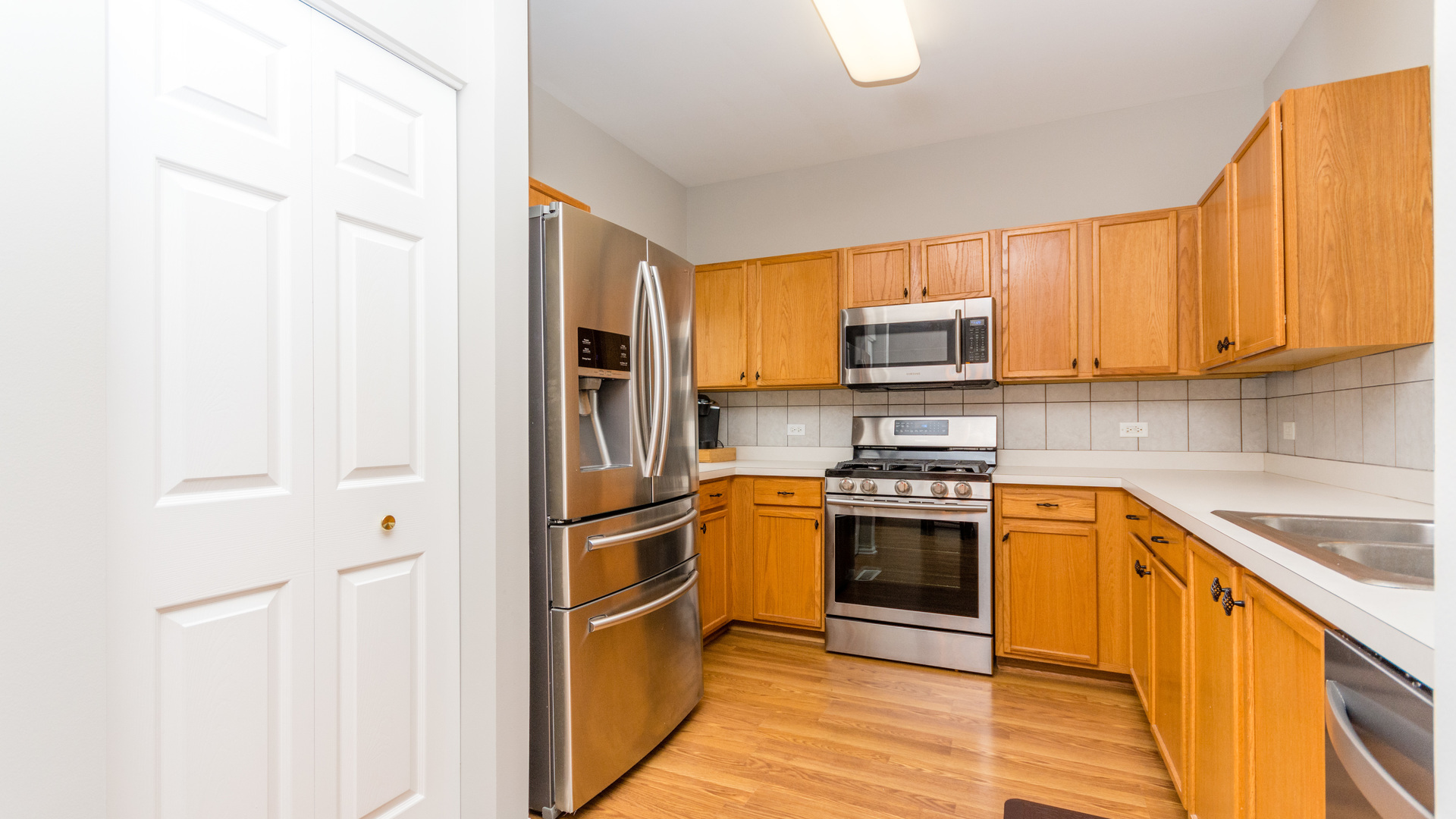 141 Enclave Circle, Unit B Bolingbrook, IL 60440 - Photo 11 of 41 a kitchen with stainless steel appliances granite countertop a stove top oven a sink and dishwasher