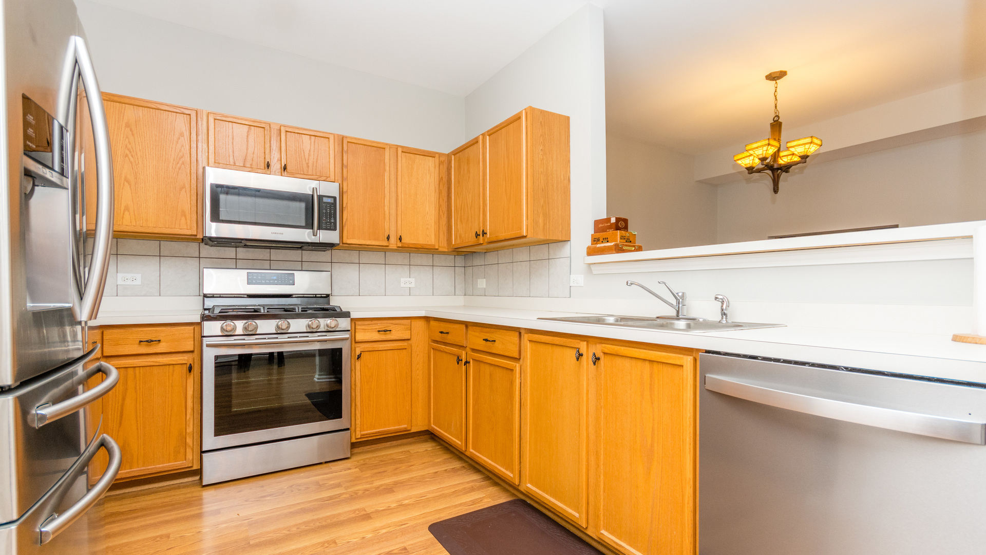 141 Enclave Circle, Unit B Bolingbrook, IL 60440 - Photo 12 of 41 a kitchen with stainless steel appliances granite countertop a sink stove and microwave