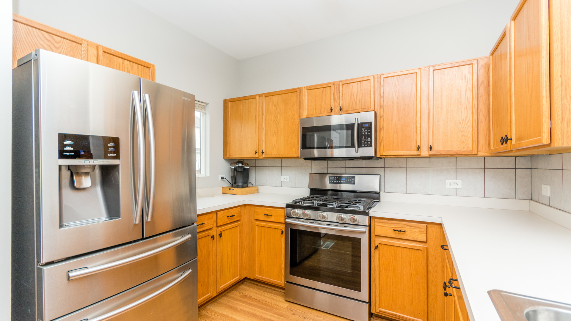 141 Enclave Circle, Unit B Bolingbrook, IL 60440 - Photo 13 of 41 a kitchen with stainless steel appliances a stove sink and microwave