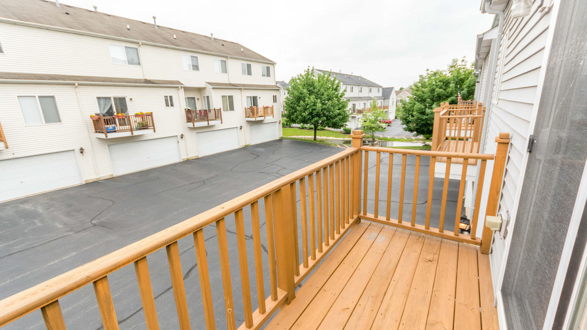 141 Enclave Circle, Unit B Bolingbrook, IL 60440 - Photo 20 of 41 a view of a balcony with wooden floor and fence