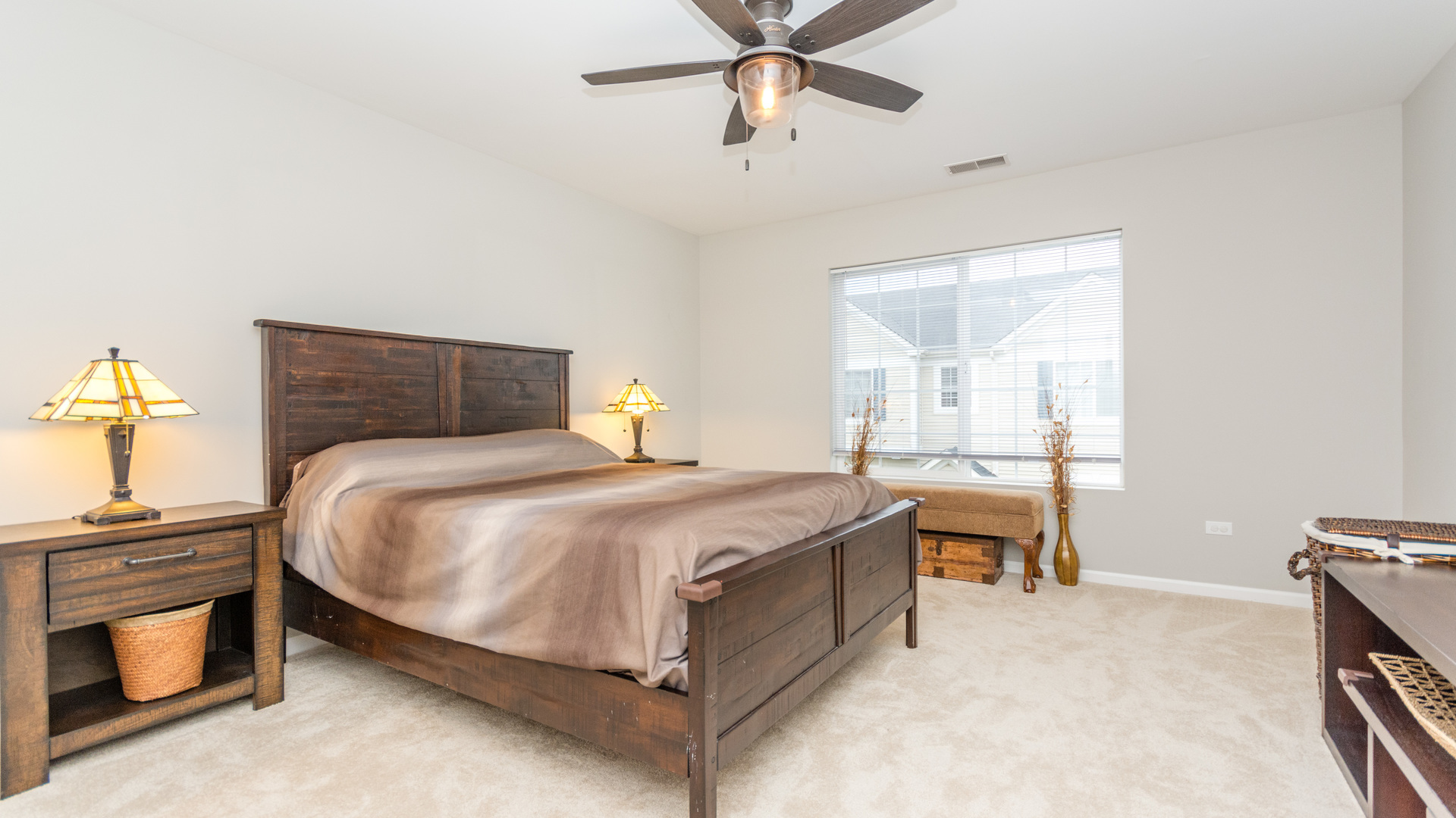 141 Enclave Circle, Unit B Bolingbrook, IL 60440 - Photo 26 of 41 a bedroom with a bed and a chandelier