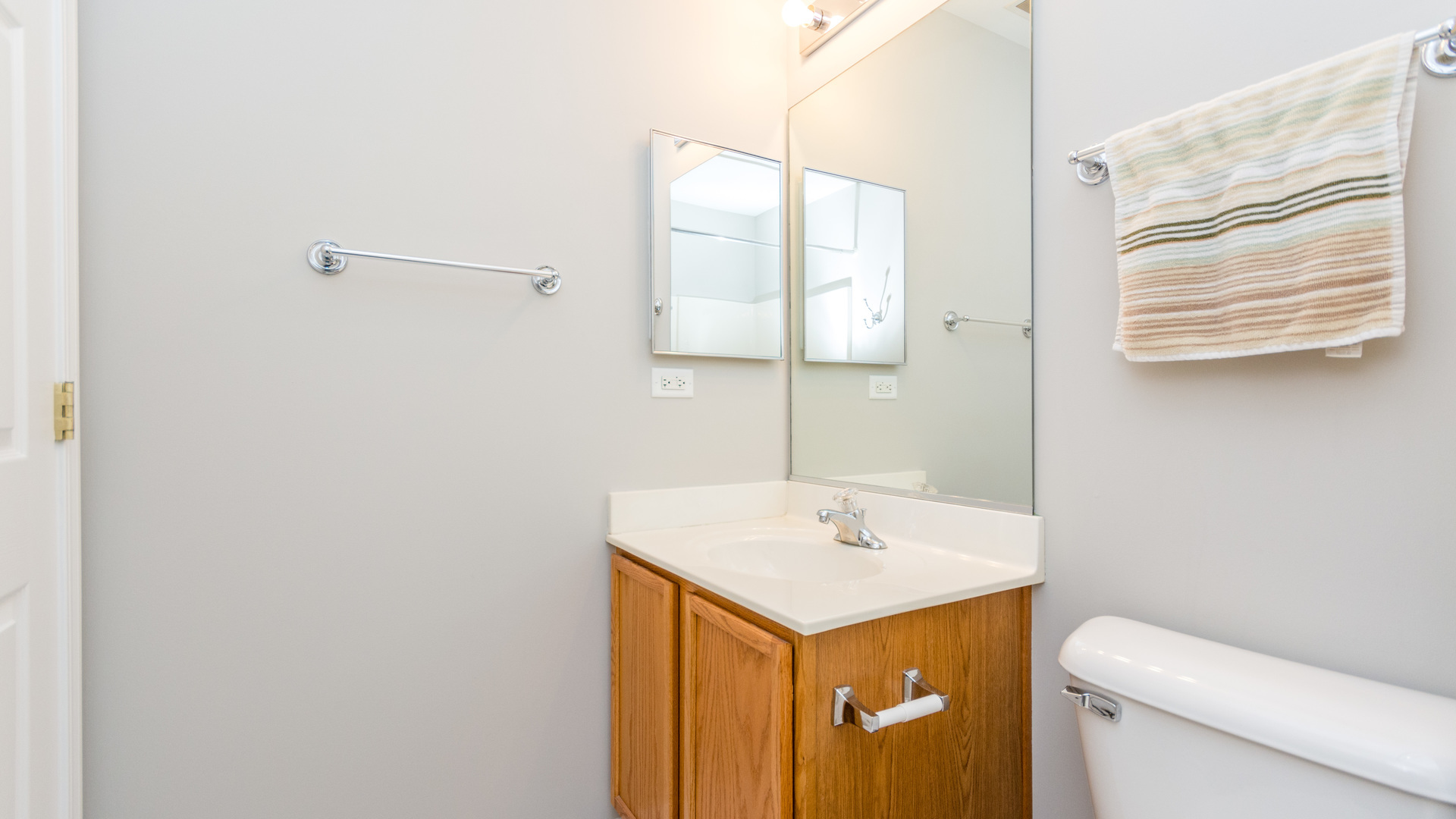 141 Enclave Circle, Unit B Bolingbrook, IL 60440 - Photo 33 of 41 a bathroom with a sink a toilet and mirror