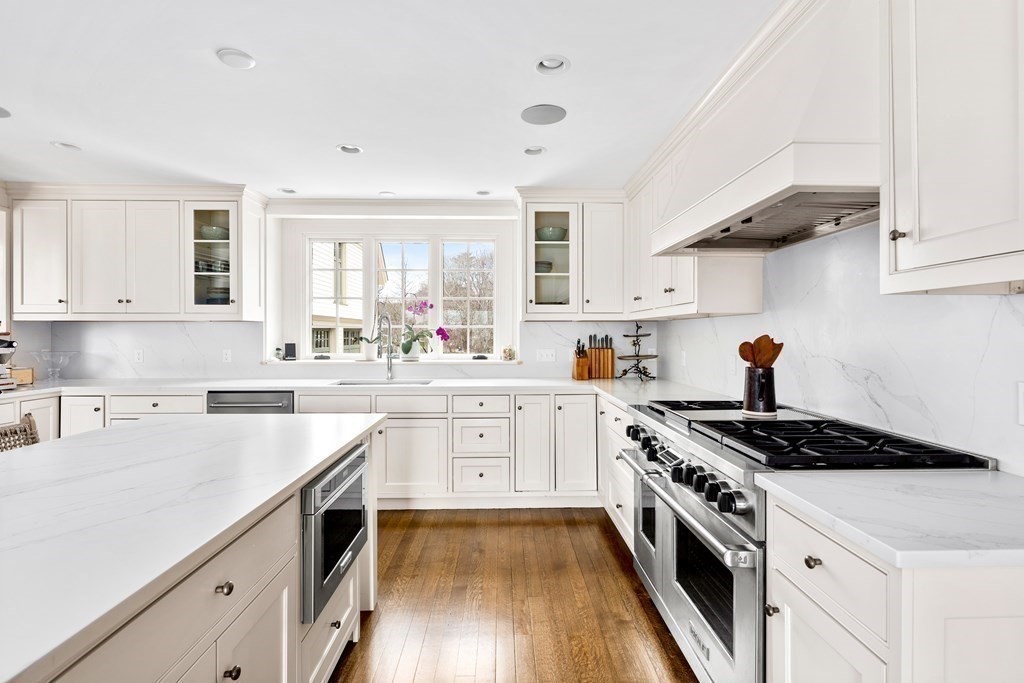 15 Old Neck Road Manchester, MA 01944 - Photo 12 of 24 a kitchen with stainless steel appliances a sink dishwasher stove and white cabinets with wooden floor