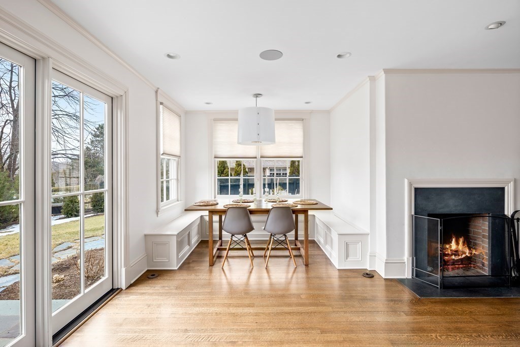 15 Old Neck Road Manchester, MA 01944 - Photo 13 of 24 a dining room with wooden floor a chandelier a glass table and windows