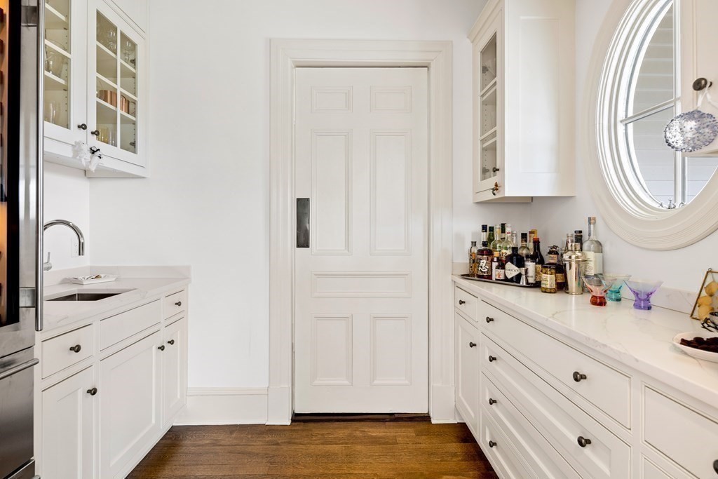 15 Old Neck Road Manchester, MA 01944 - Photo 14 of 24 a kitchen with white cabinets and sink