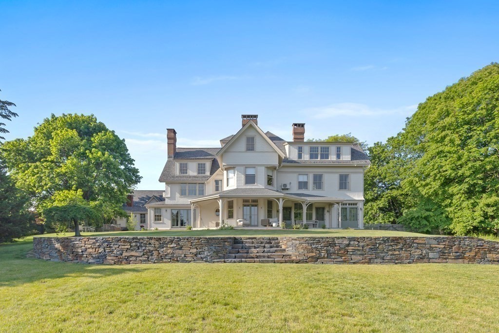 15 Old Neck Road Manchester, MA 01944 - Photo 4 of 24 a front view of house with yard and trees in the background