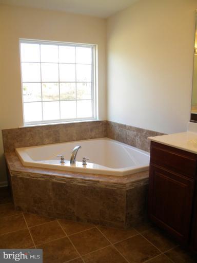 6375 Windy Creek Road Huntingtown, MD 20639 - Photo 4 of 5 a bath tub sitting next to a window