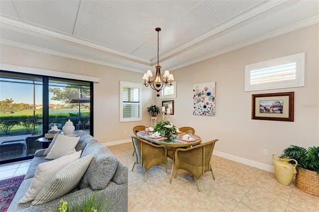 a bedroom with a bed a dresser next to a window