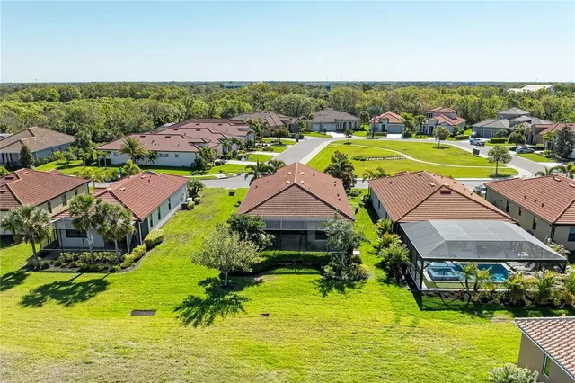 a living room with furniture wooden floor and a large window
