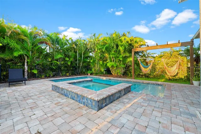 a view of outdoor space with pool and trees in the background