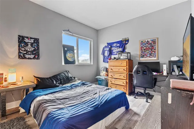 a bedroom with a bed and wooden floor
