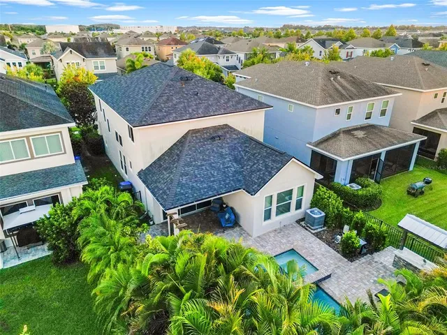 an aerial view of multiple houses with a yard