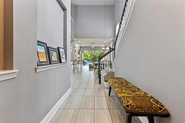 a hallway with chairs and a potted plant