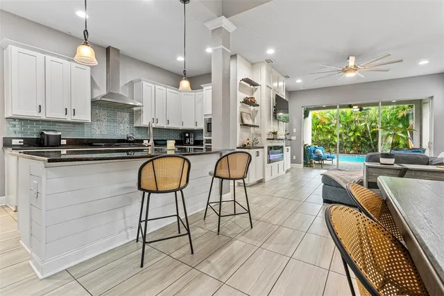 a kitchen with stainless steel appliances kitchen island granite countertop a stove a sink and a granite counter tops