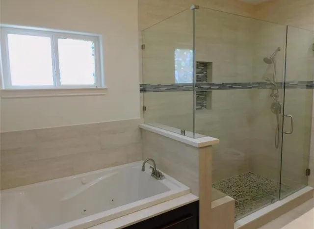a bathroom with a shower and a bathtub