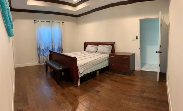 a spacious bedroom with a bed and a table