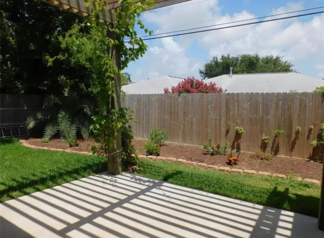 a view of a backyard with a table and chairs