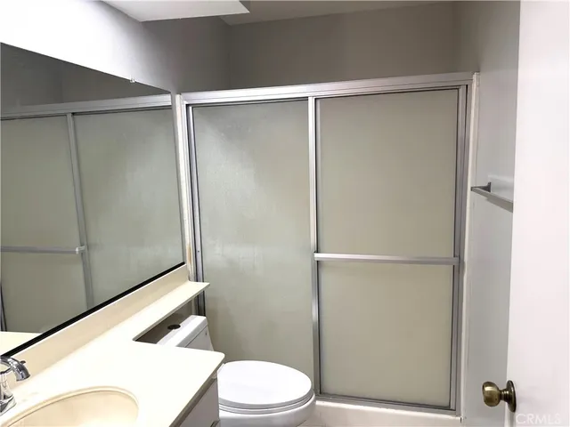 a bathroom with a toilet and a shower