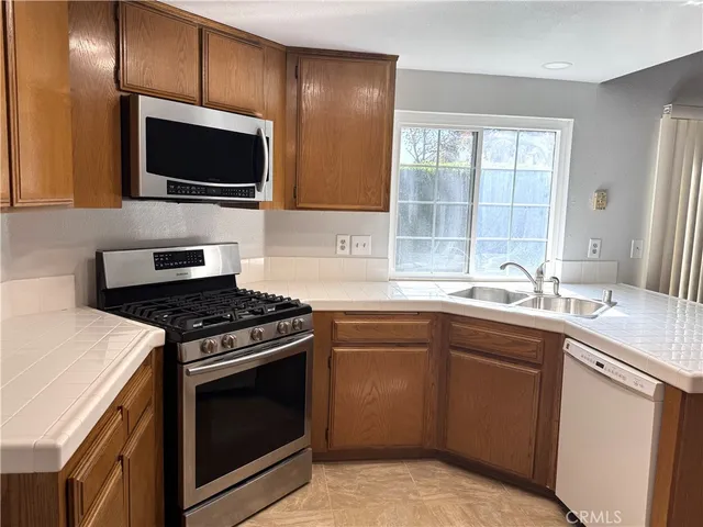 a kitchen with a sink stove and microwave