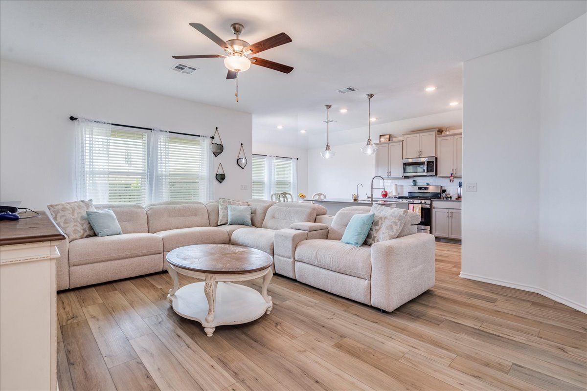 389 Salt Springs Road Kyle, TX 78640 - Photo 28 of 30 An inviting open floorplan seamlessly connects the living room to the kitchen, promoting effortless flow and social interaction.