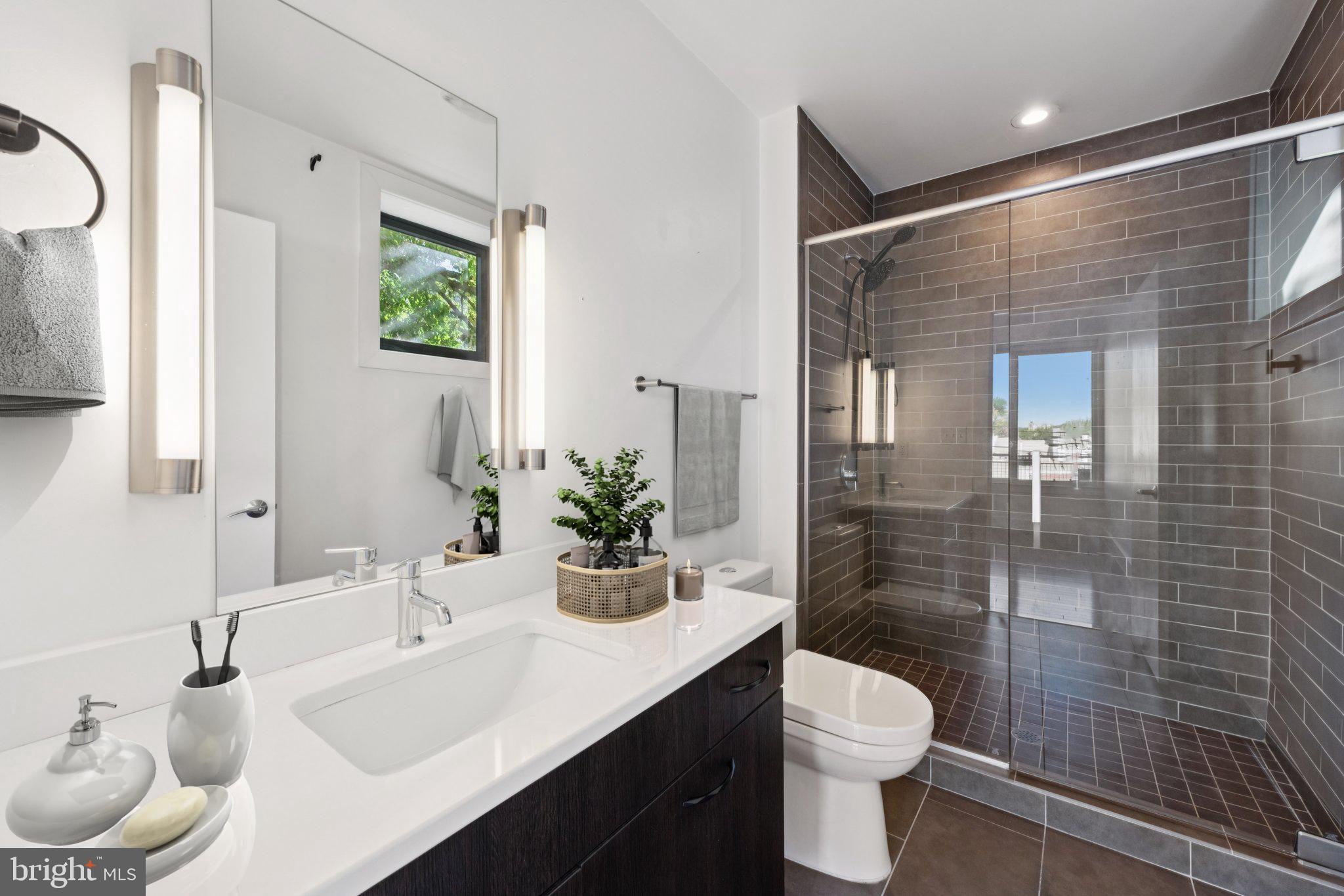 1767 Lanier Place Northwest, Unit 6 Washington, DC 20009 - Photo 11 of 49 a bathroom with a toilet sink a mirror and shower