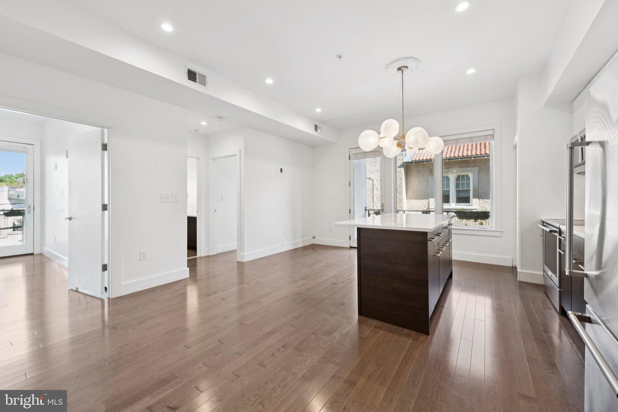 1767 Lanier Place Northwest, Unit 6 Washington, DC 20009 - Photo 21 of 49 a view of a kitchen center island wooden floor and stainless steel appliances