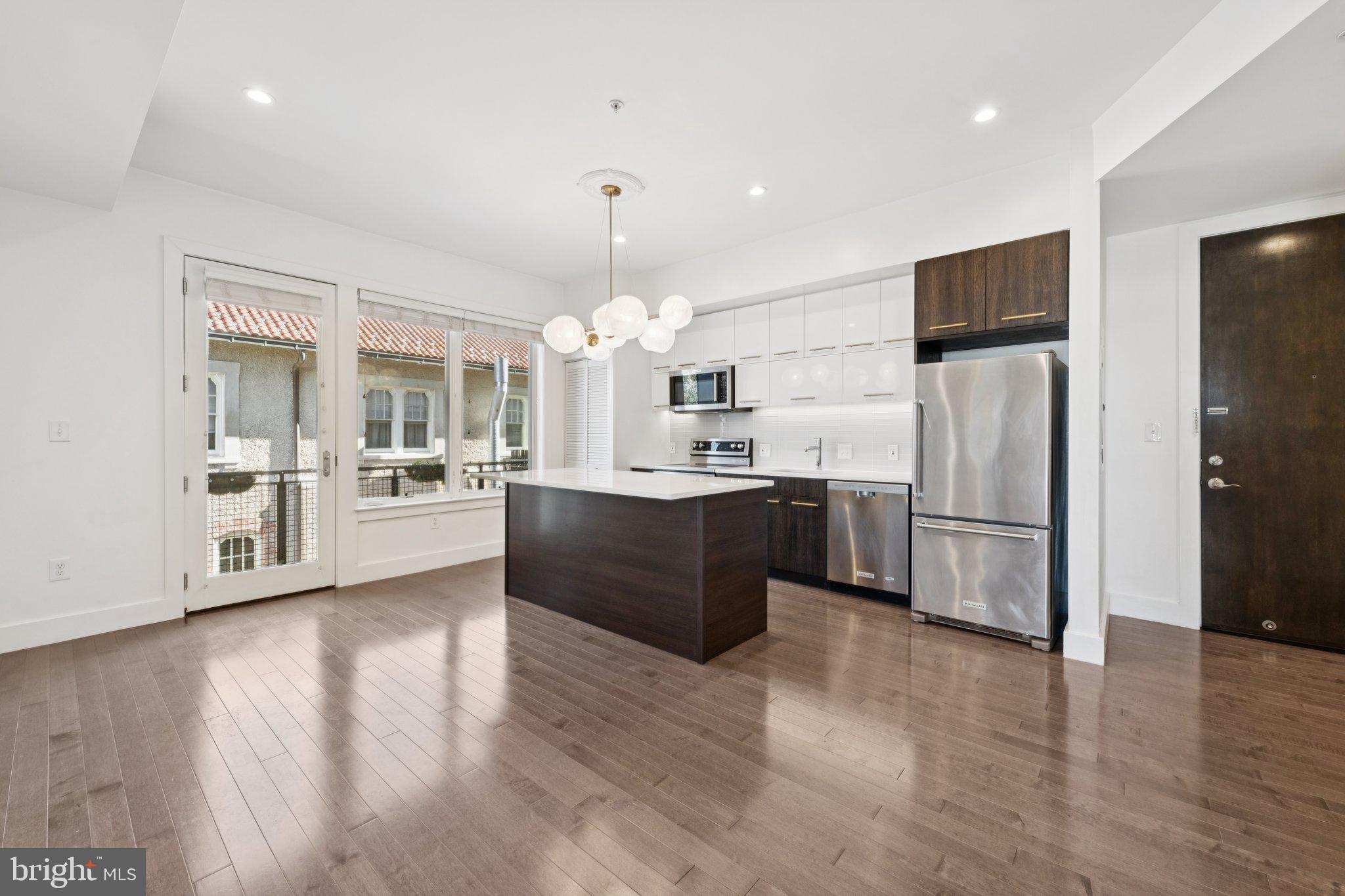 1767 Lanier Place Northwest, Unit 6 Washington, DC 20009 - Photo 22 of 49 a large kitchen with a refrigerator and wooden floor