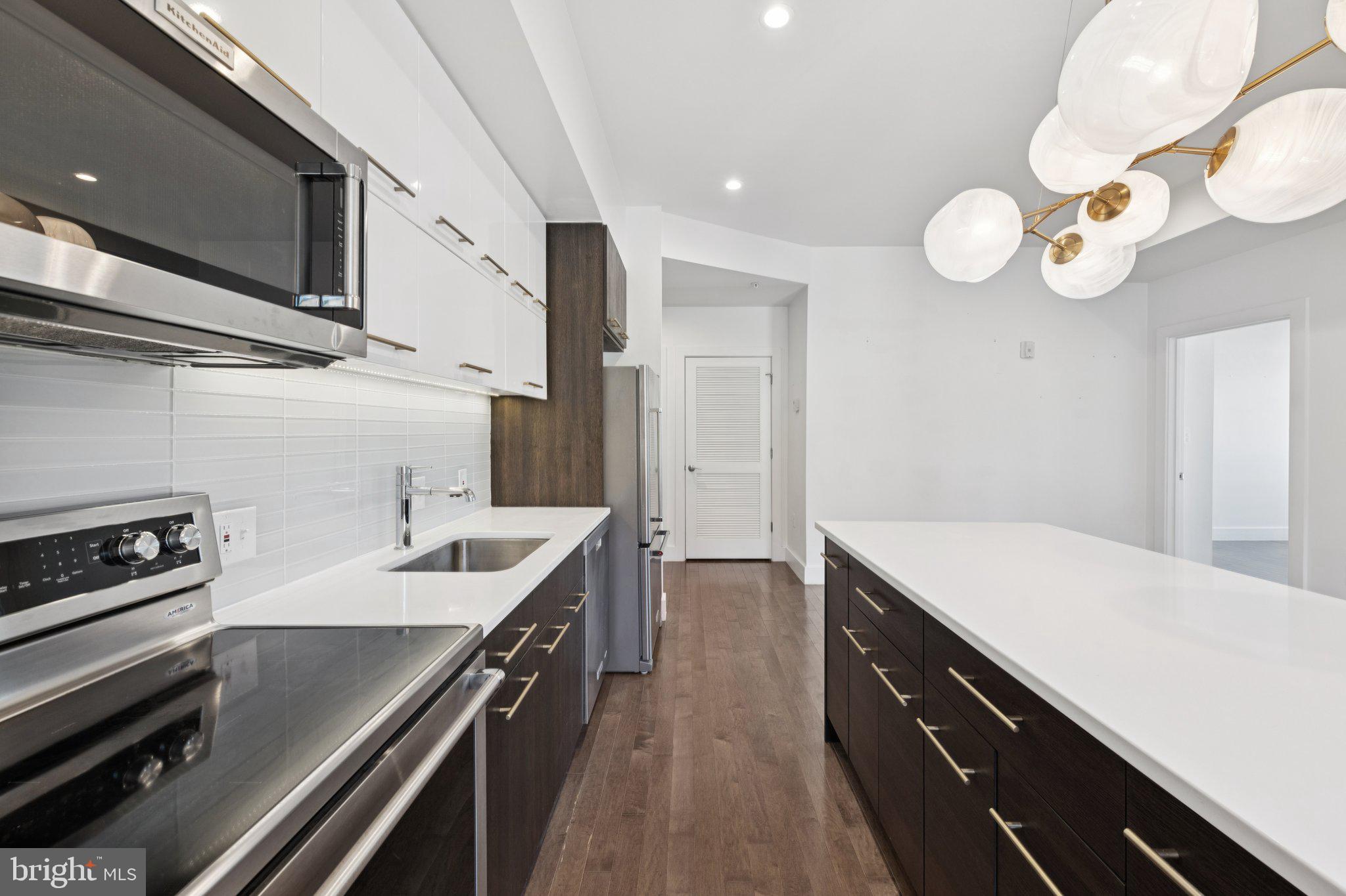 1767 Lanier Place Northwest, Unit 6 Washington, DC 20009 - Photo 27 of 49 a kitchen with a sink appliances and cabinets