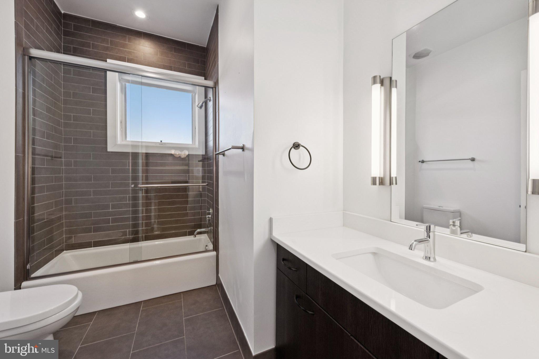 1767 Lanier Place Northwest, Unit 6 Washington, DC 20009 - Photo 34 of 49 a bathroom with a sink a toilet and shower