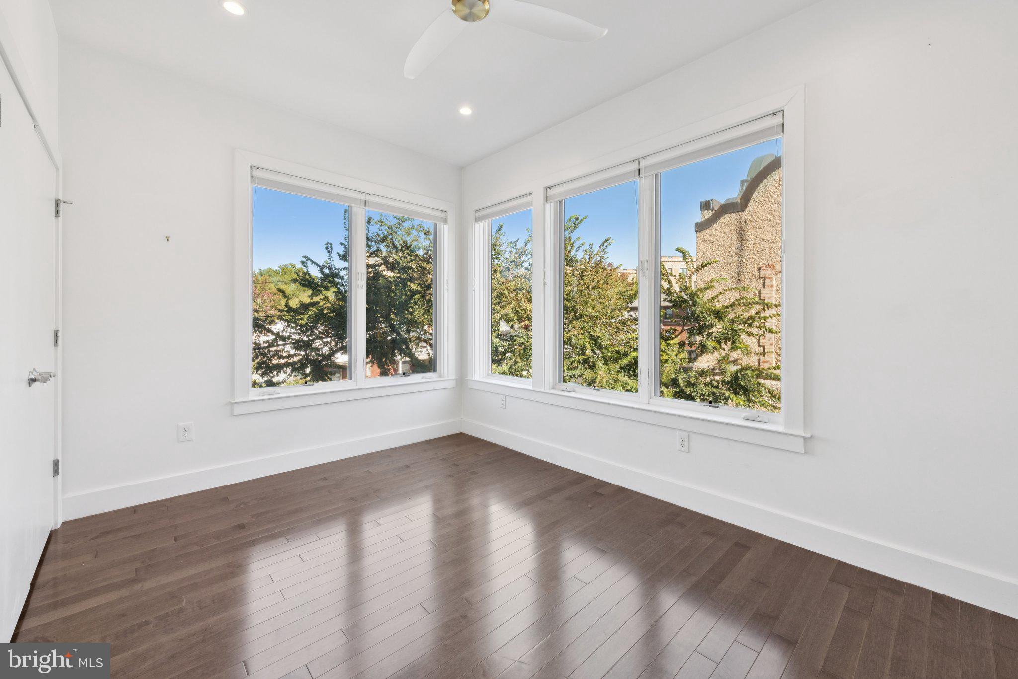 1767 Lanier Place Northwest, Unit 6 Washington, DC 20009 - Photo 36 of 49 an empty room with wooden floor and windows